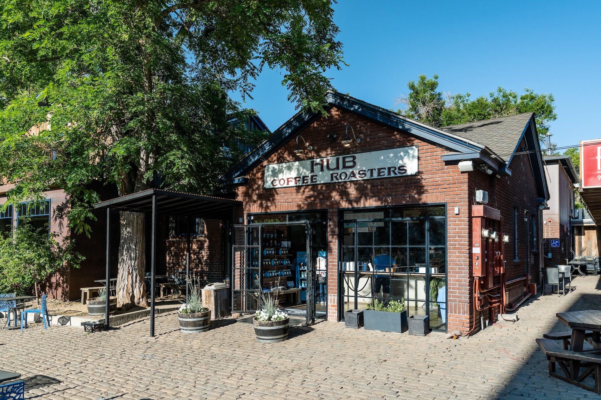 Hub Coffee Roasters building with outdoor seating area on a sunny day